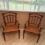 Set Of 2, 1960S Vintage Carved Faux Bamboo And Cane Chairs Used. Price: $1800.00.